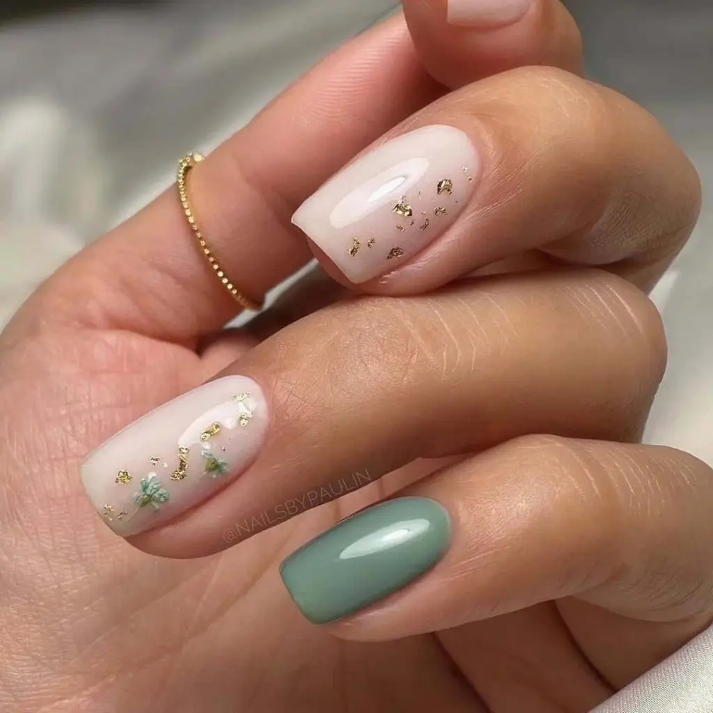 Milky white nails with gold flakes and mint green flowers, soft sage accent nail