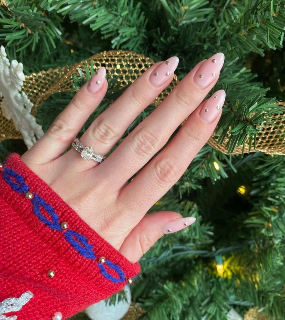 sheer Pink nails with tiny metallic dots minimal new years nail art