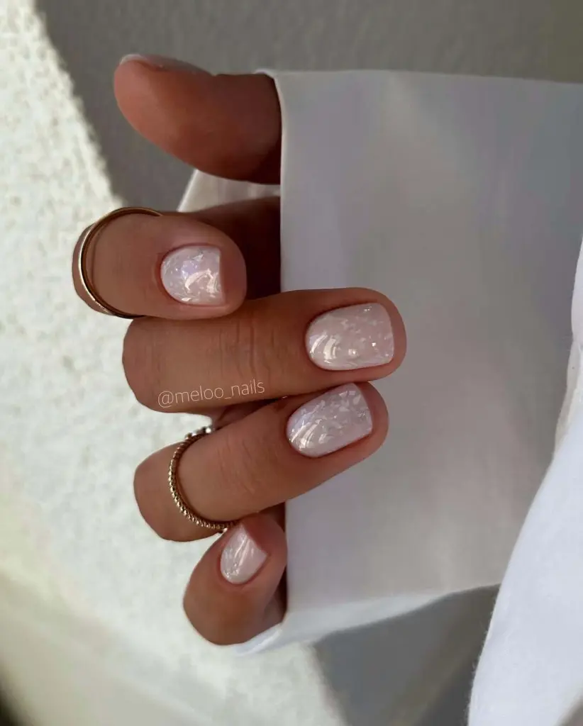 Pearl white nails with iridescent flakes winter new years design