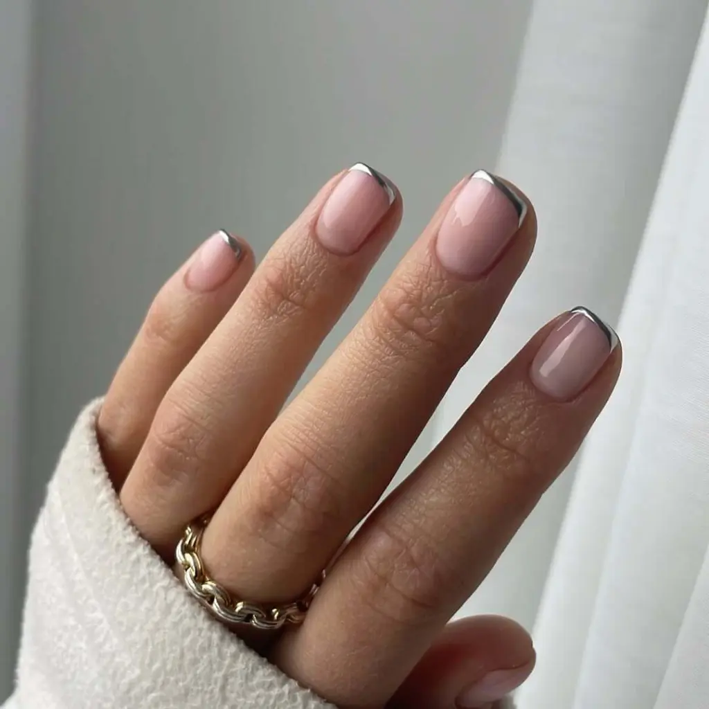 Classic French manicure with thin silver tips on nude base for january