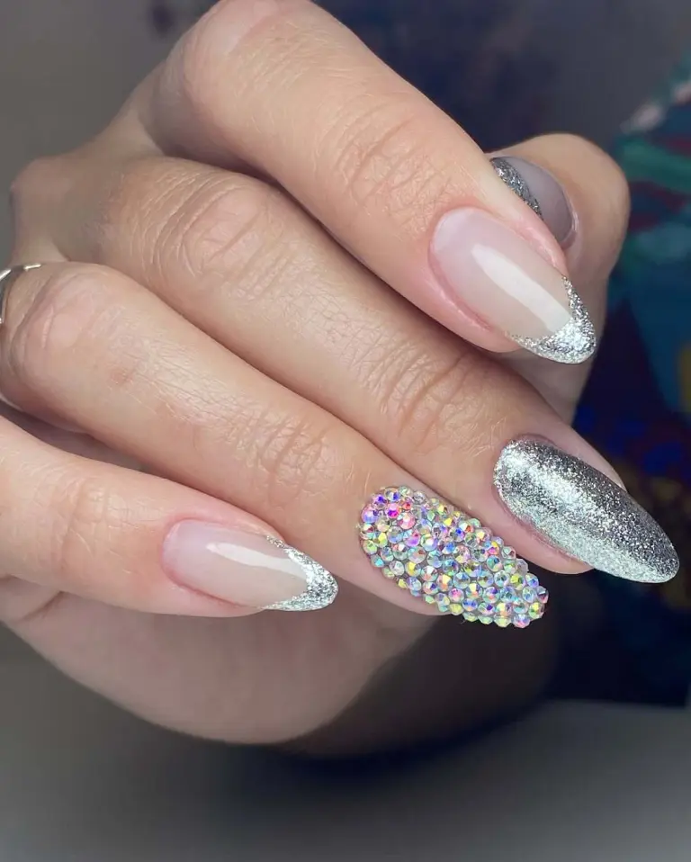 Crystal covered accent nail with silver glitter tips new years design