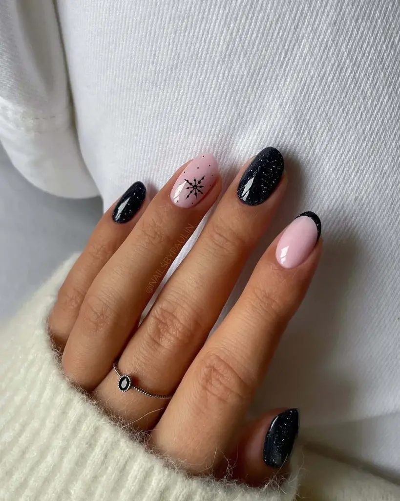 sparkling Black and nude pink nails with star compass design winter nail art