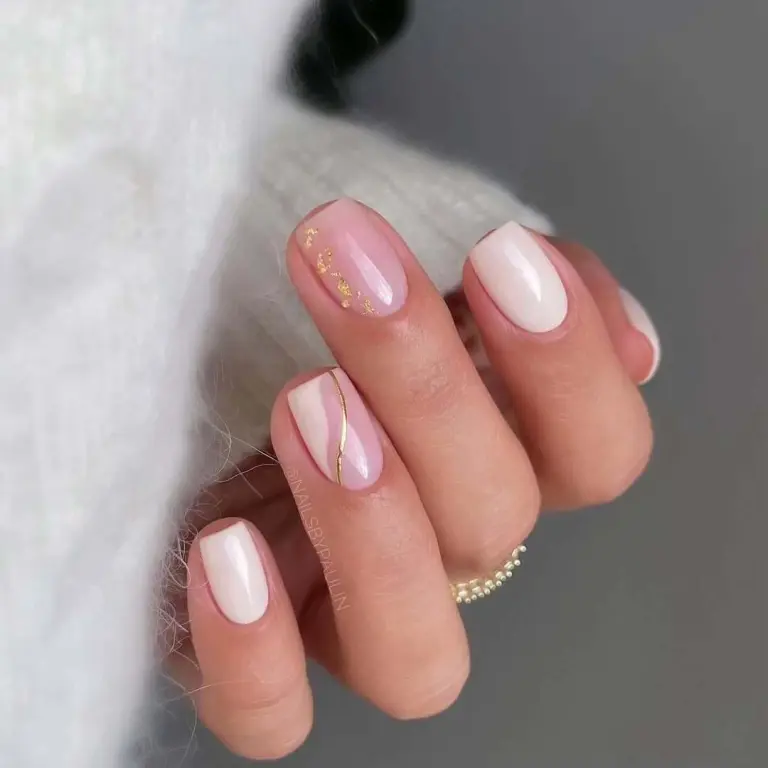 Minimal soft pink nails with gold stripe accent and subtle gold flakes for winter