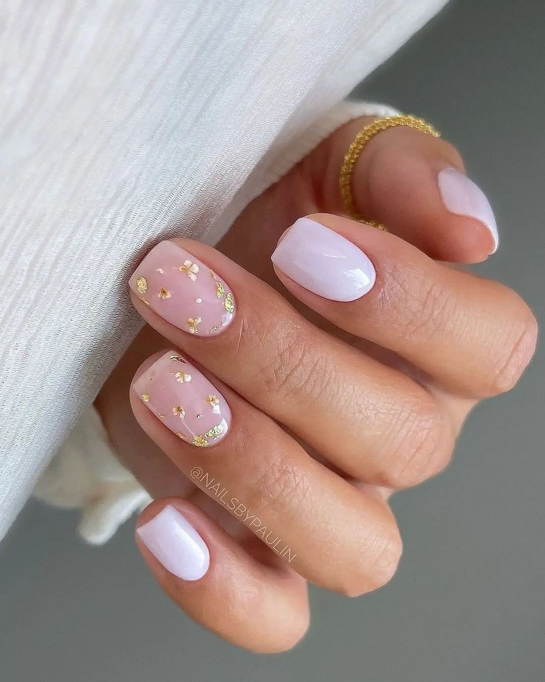 white flowers on sheer pink and white nails