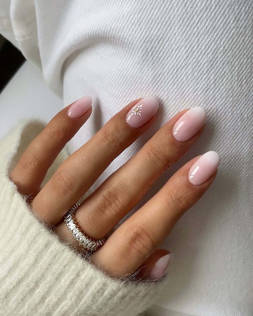 Neutral pink nails with delicate snowflake art for winter nails