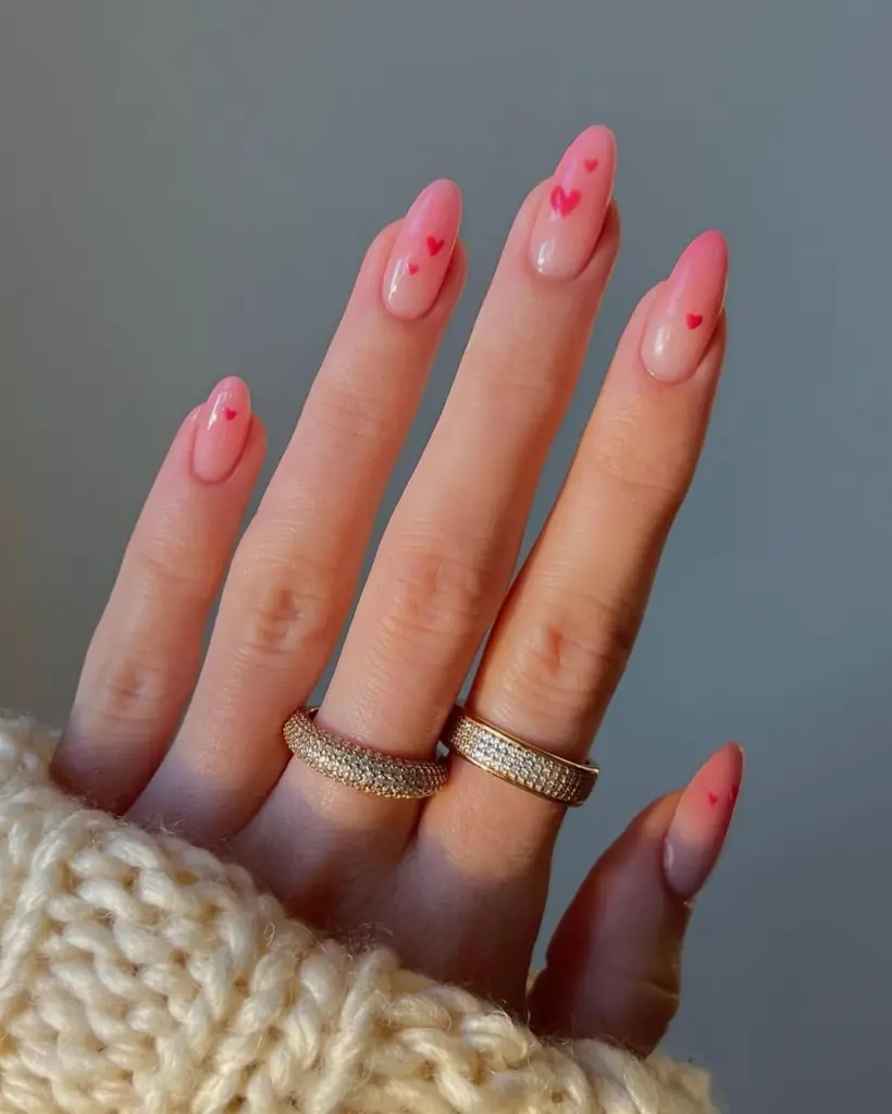 Sheer pink gradient Valentine day nails with red heart accents