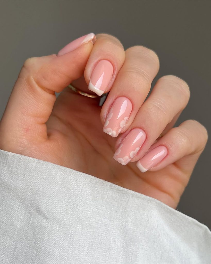 Sheer pink spring nails with delicate white floral accent nail