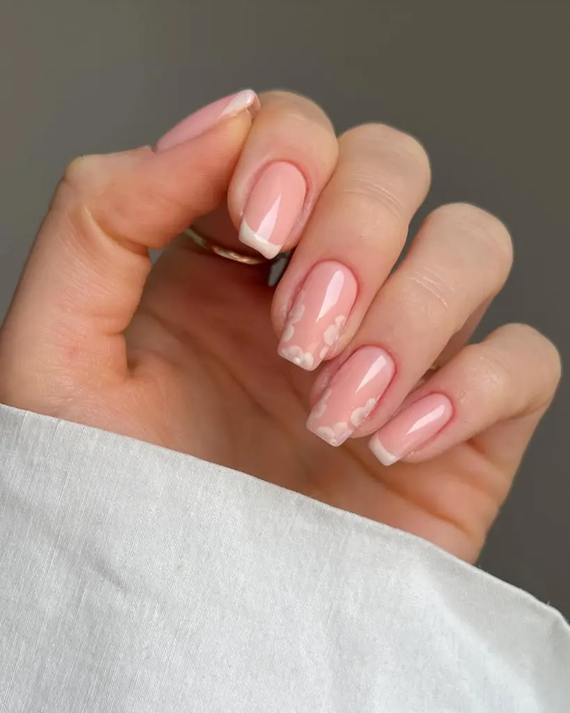 Sheer pink spring nails with delicate white floral accent nail
