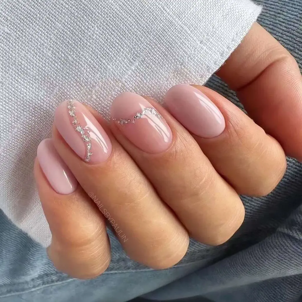 Pink short nails with diagonal crystal details