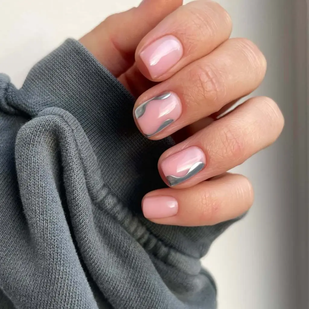 Pink nails with silver wave design accent