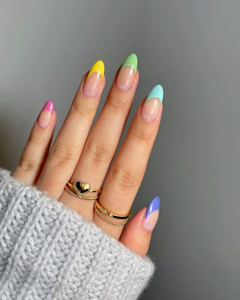 Sheer pink nails with multicolored pastel French tips

