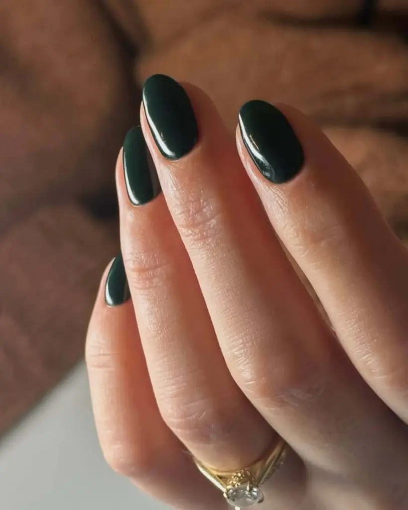 Deep green oval nails with glossy finish