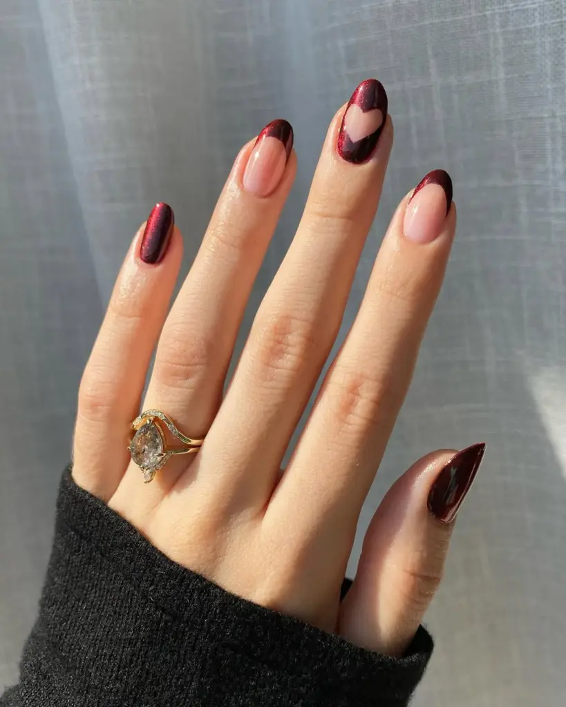 Long almond nails with burgundy french tips and negative space heart
