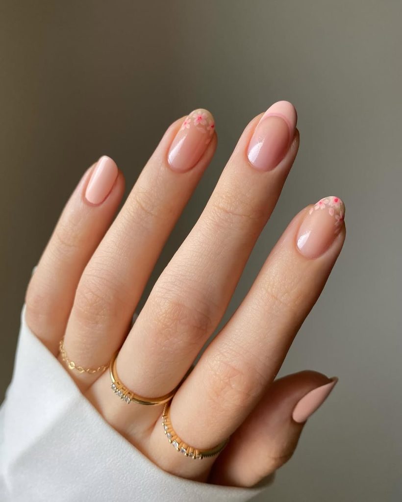Almond spring nails with sheer pink base and cherry blossom french tip design