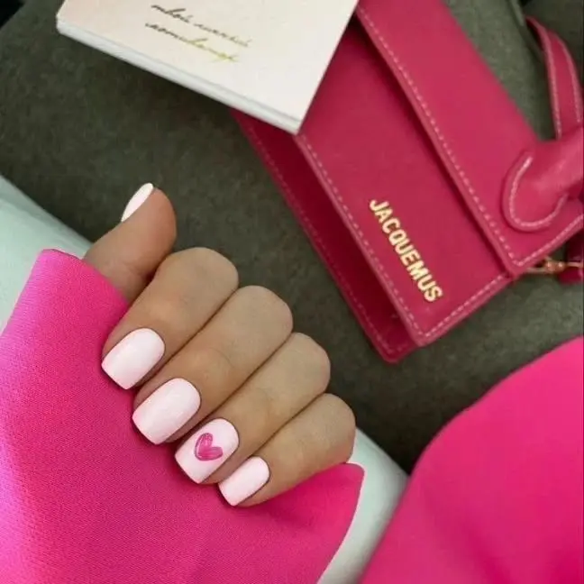 Short pink valentine day nails with pink heart accent
