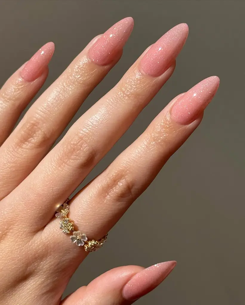 Long almond nails with sheer pink shimmer polish