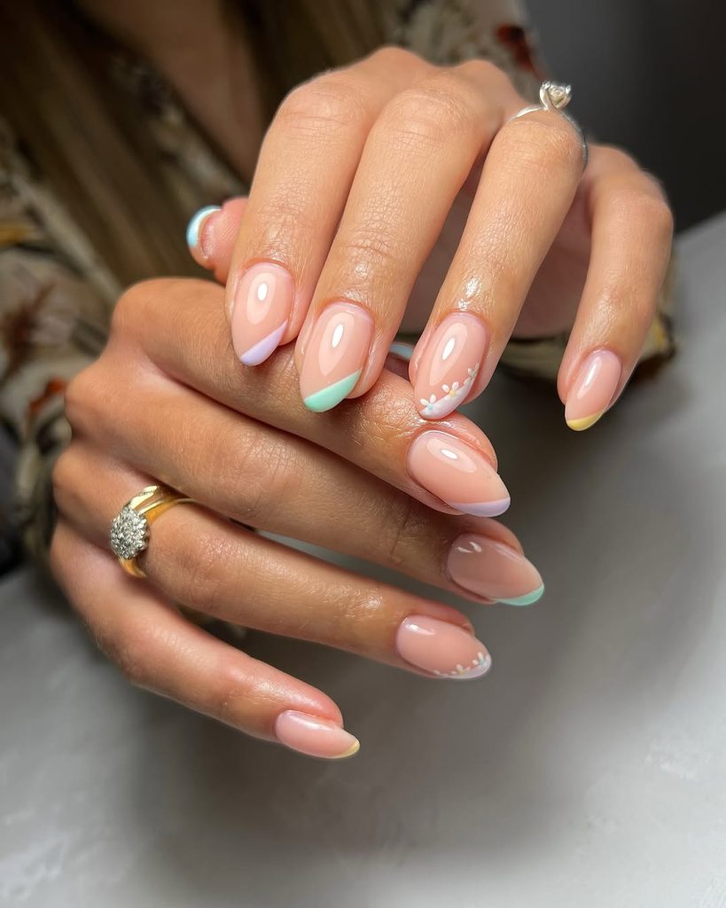 Almond spring nails with sheer nude base and alternating pastel micro French tips
