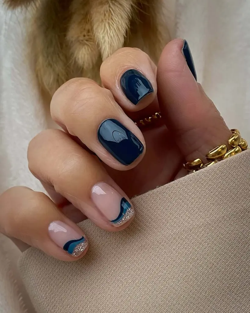 Navy and nude short nails with silver glitter wave accent