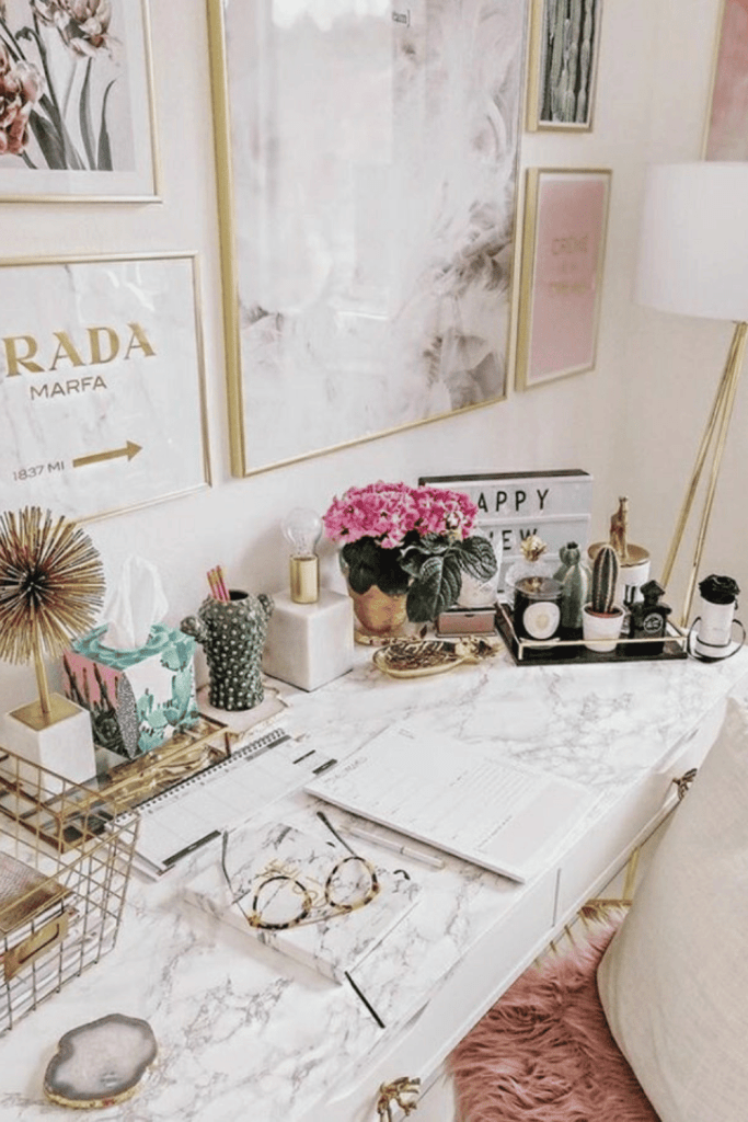 a desk cluttered with feminine office decorations
