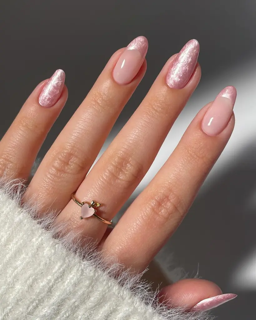 Sheer pink nails with pearlescent French tips and almond shape
