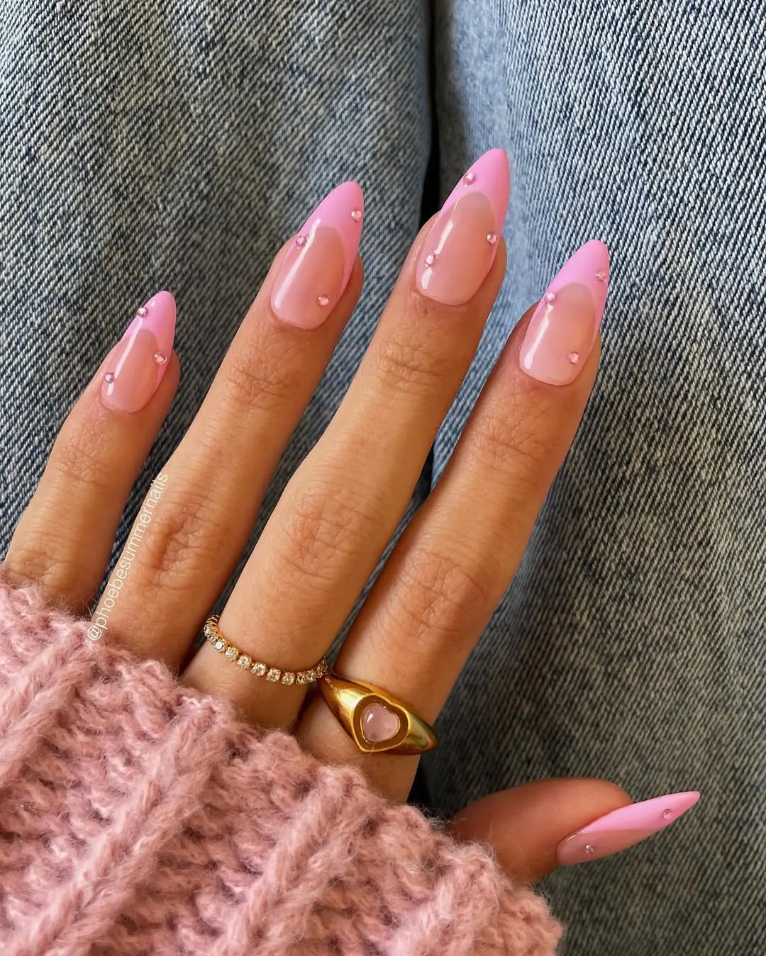 Long almond nails with light pink base, pink French tips and crystal accents