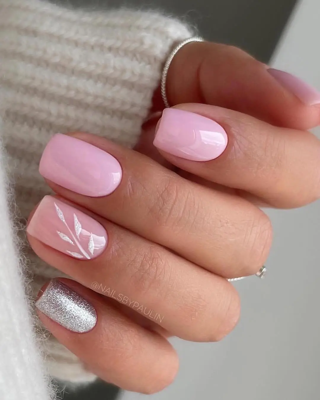 Short square pink nails with white floral accent and chrome silver nail