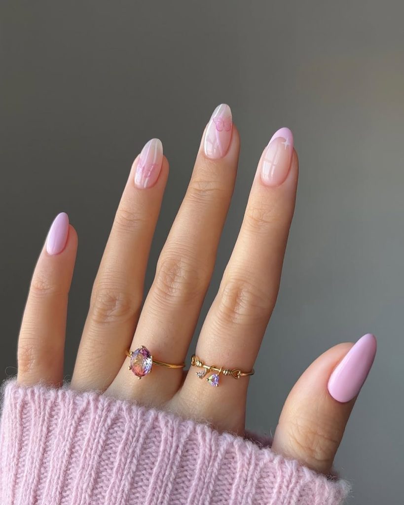 Almond spring nails with sheer pink base, pink French tips and solid pink accent nails
