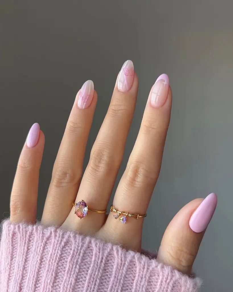 Almond spring nails with sheer pink base, pink French tips and solid pink accent nails