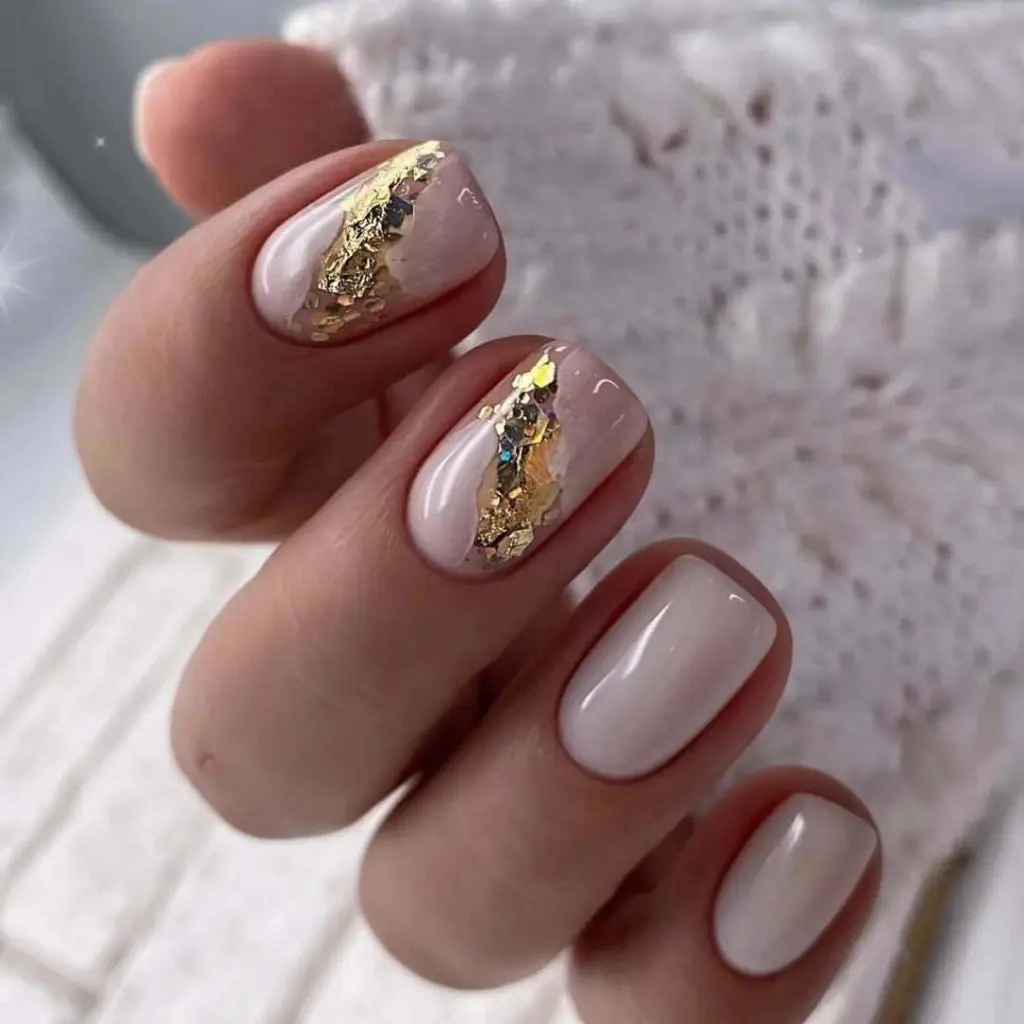 White square nails with diagonal gold foil accent