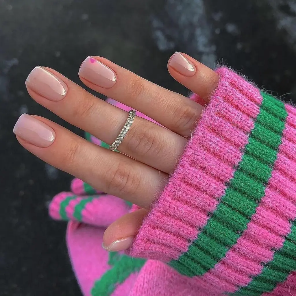 Short sheer pink nails with glazed finish and heart accent