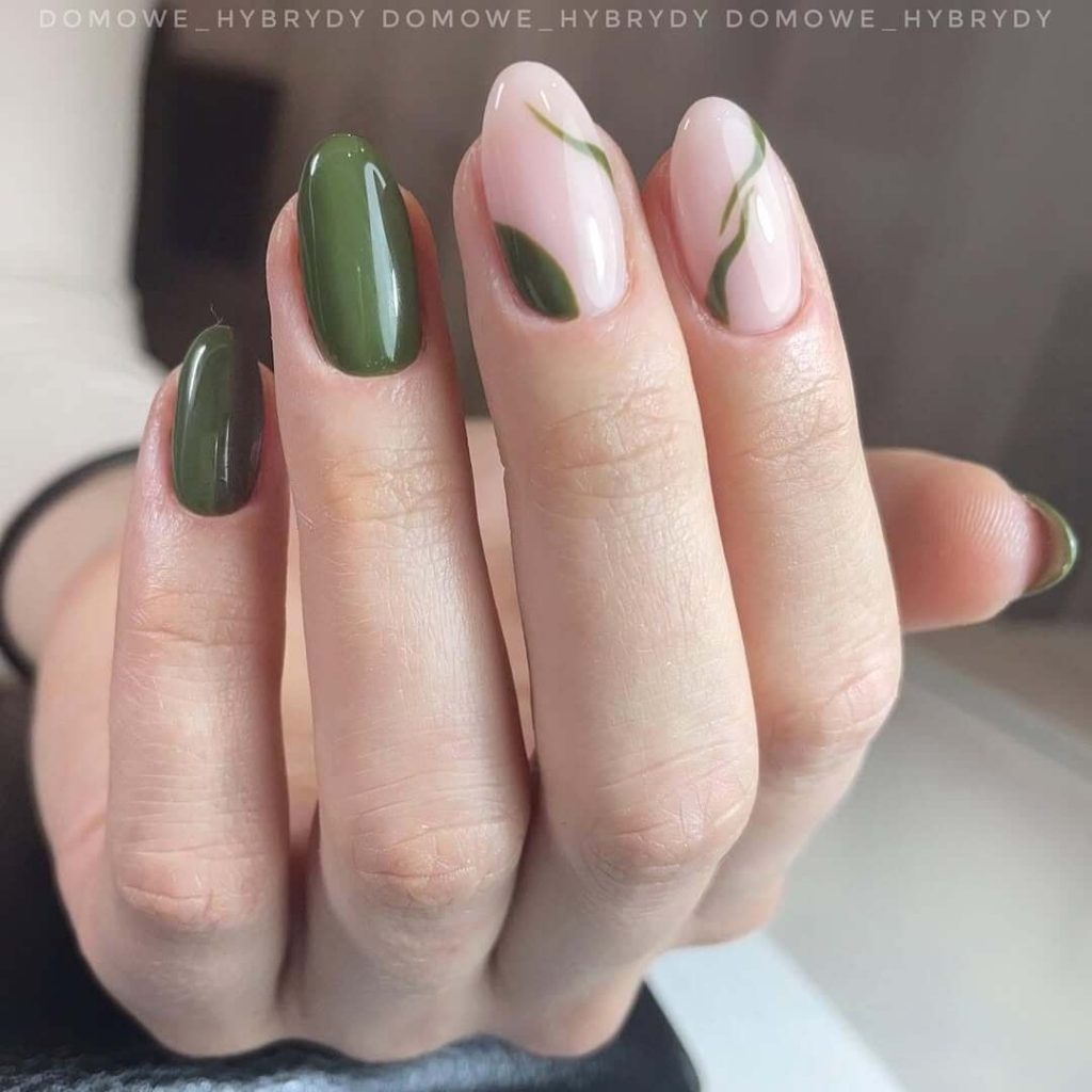 Milky pink and olive nails with delicate green swirl design