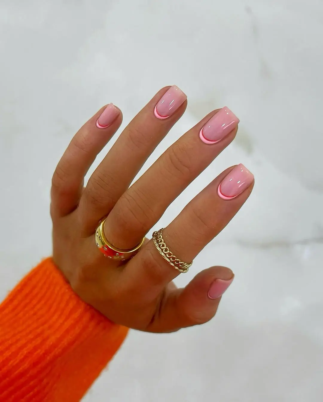Short pink nails with curved double line design