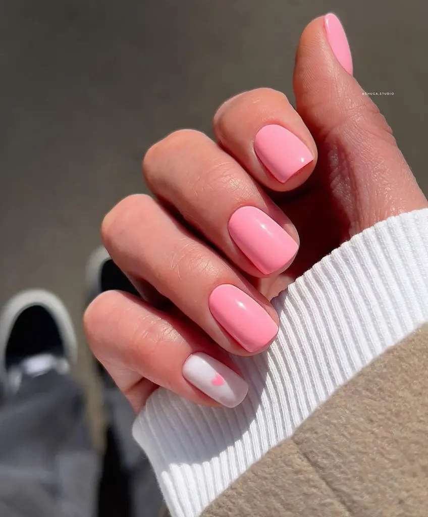 Short pink and white nails with pink heart accent