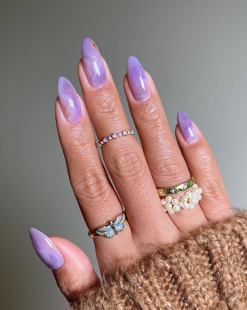 Lavender almond nails with marble swirl effect for spring

