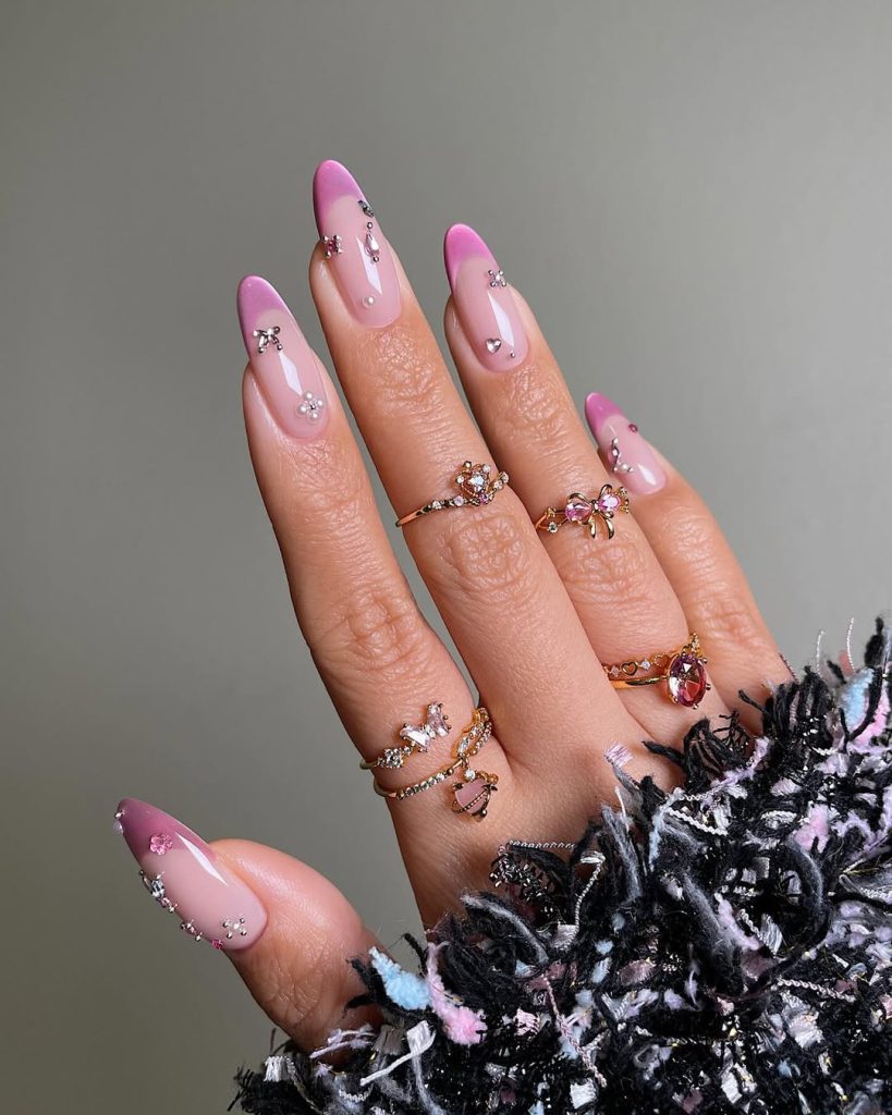 Pink French tip nails with rhinestone accents