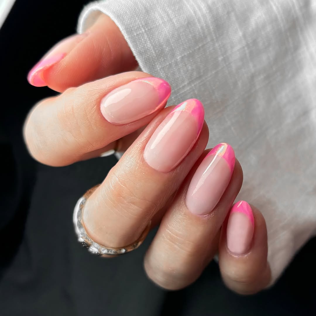 Long almond nails with light pink base and thin chrome pink French tips
