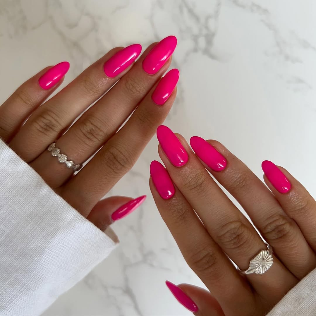 Long almond nails with bright magenta polish