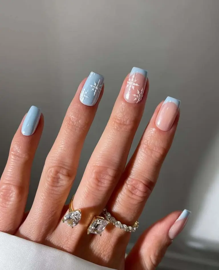 French tips with snowflake nail art in blue and white nails for winter