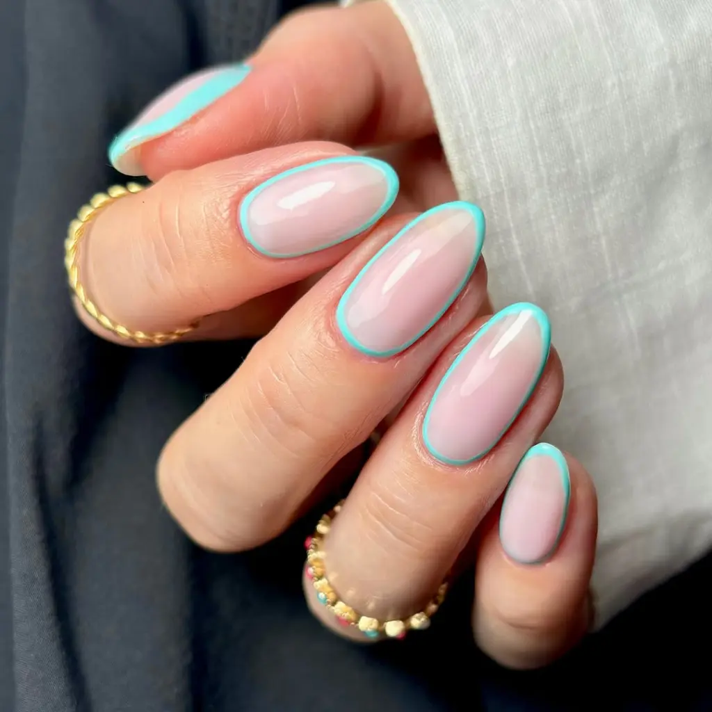Elegant almond nails with milky nude base and thin aqua blue outline spring design