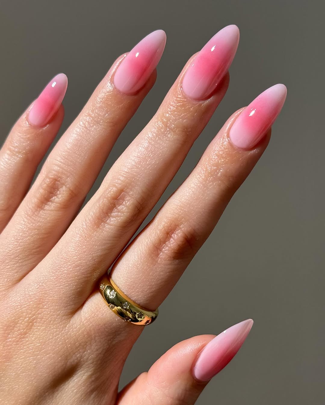 Long almond nails with pink to red ombre gradient design