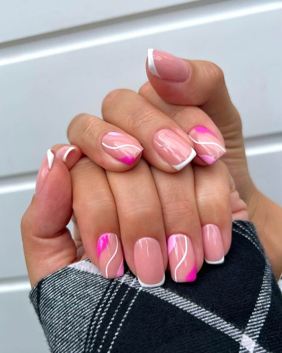 Square pink nails with white swirls and hot pink abstract accents