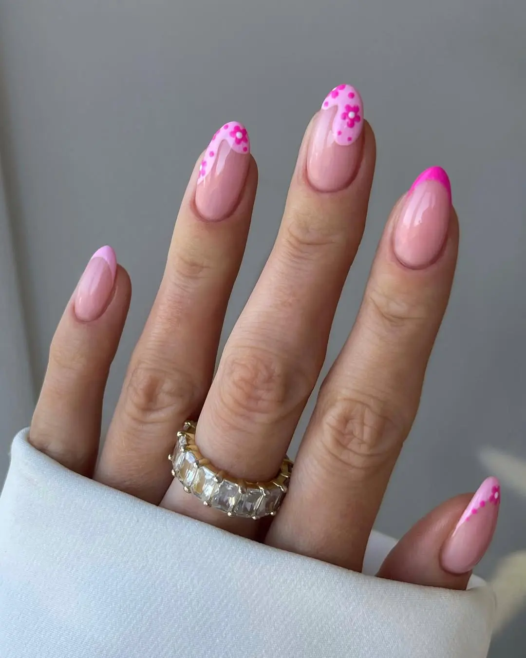 Long almond nails with pink base and hot pink floral dot tips