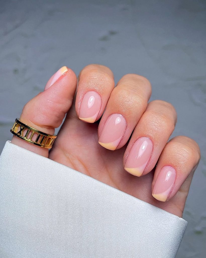 Elegant short square spring nails with sheer pink base and peach french tips