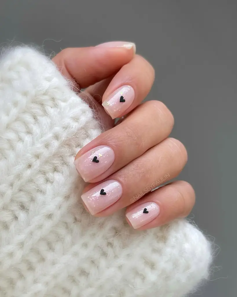 Pink nails with tiny black heart accents
