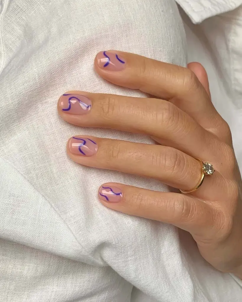 Short nude nails with bright purple abstract line art