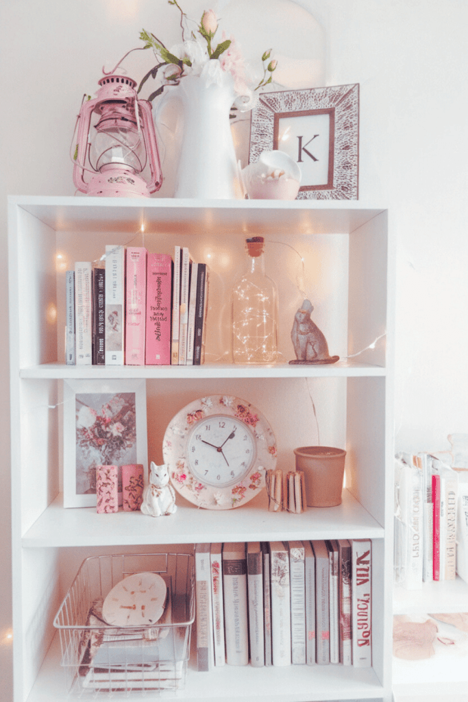 A white shelving unit filled with various decorative and functional items