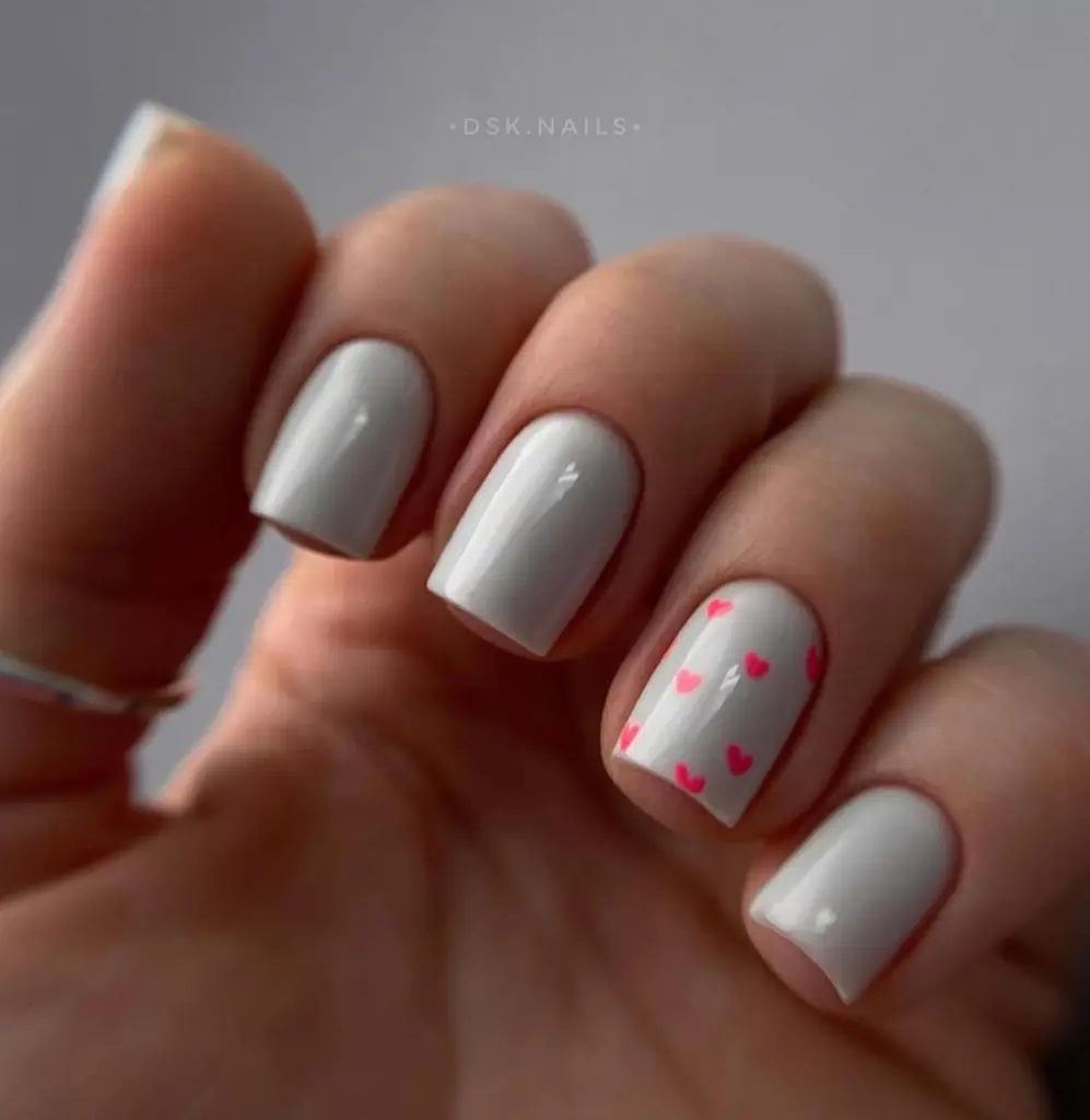 Short white nails with pink heart designs