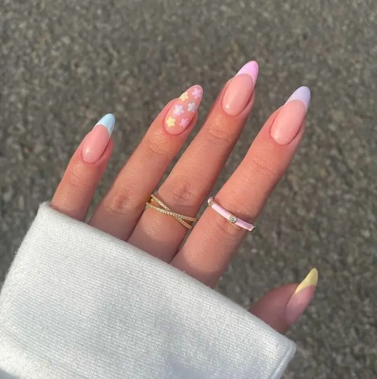 Long almond spring nails with nude base, pastel French tips and floral accent nail design