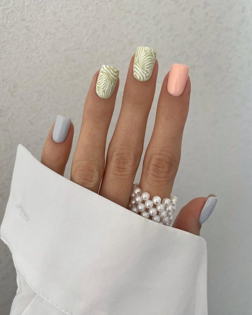 Classy square nails with sage green zebra pattern, peach, and light blue polish