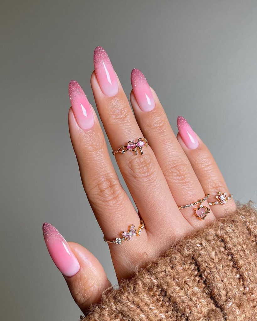Pink ombré nails with glitter tips on almond shape